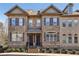 Charming townhome exterior featuring brick facade, shuttered windows, and landscaped entrance at 911 Telfair Close, Sandy Springs, GA 30350