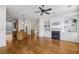 Open floor plan featuring hardwood floors, a kitchen island, fireplace, and built-in shelving at 911 Telfair Close, Sandy Springs, GA 30350