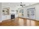 Cozy living room features built-in shelving, fireplace, hardwood floors, and French doors to a patio at 911 Telfair Close, Sandy Springs, GA 30350