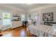 A bedroom featuring hardwood floors and two windows at 3670 Union Ave, Atlanta, GA 30354