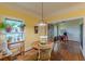 Inviting dining area with hardwood floors, vintage lighting, and views to the study at 3670 Union Ave, Atlanta, GA 30354