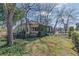 Charming home exterior featuring an overgrown porch with mature trees and a well-maintained lawn at 3670 Union Ave, Atlanta, GA 30354