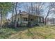 Older home with a covered front porch with mature vines and landscaping at 3670 Union Ave, Atlanta, GA 30354