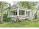 Charming home featuring a covered porch with classic white columns and railings at 3670 Union Ave, Atlanta, GA 30354