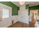 Kitchen area featuring wooden floors, green walls, and a backdoor entryway at 3670 Union Ave, Atlanta, GA 30354