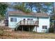 Backyard view with a wooden deck, offering an inviting outdoor space, perfect for relaxation and entertaining at 5087 Fairmont Se Rd, Smyrna, GA 30082