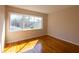 Cozy bedroom with hardwood floors and a large window offering natural light at 5087 Fairmont Se Rd, Smyrna, GA 30082