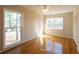 Bedroom with hardwood floors and large window overlooking the backyard at 5087 Fairmont Se Rd, Smyrna, GA 30082