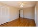 Bedroom with hardwood floors, ceiling fan, and double closet at 5087 Fairmont Se Rd, Smyrna, GA 30082