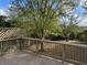 Lovely deck with wooden railing and lattice feature, overlooking a spacious backyard with mature trees at 5087 Fairmont Se Rd, Smyrna, GA 30082