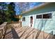 Enclosed porch boasts a deck with a railing, natural sunlight and an exterior entrance to the house at 5087 Fairmont Se Rd, Smyrna, GA 30082