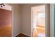 Hallway with Hardwood floors leads to a bedroom and brick walled room in this house at 5087 Fairmont Se Rd, Smyrna, GA 30082