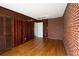 This living room offers brick accent walls and wood paneled walls, hardwood floors, and two closets at 5087 Fairmont Se Rd, Smyrna, GA 30082