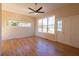 Bright living room with hardwood floors, a ceiling fan, and large windows offering plenty of natural light at 5087 Fairmont Se Rd, Smyrna, GA 30082