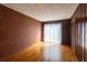 This room features hardwood floors, a brick accent wall and a large window at 5087 Fairmont Se Rd, Smyrna, GA 30082