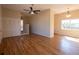 Spacious living room with hardwood floors, ceiling fan, neutral paint, closet, and natural light at 5087 Fairmont Se Rd, Smyrna, GA 30082