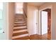 A wood staircase leads to the upper level, with a door and closet for storage along the way at 5087 Fairmont Se Rd, Smyrna, GA 30082