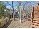 View of the backyard, wooded area, and deck of the home at 1069 Falling Water Se Dr, Smyrna, GA 30080