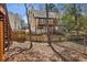 Backyard and exterior of home featuring a deck with trees and fencing at 1069 Falling Water Se Dr, Smyrna, GA 30080