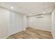 Finished basement with AC unit, drop ceiling, light wood floors, and closet at 1069 Falling Water Se Dr, Smyrna, GA 30080