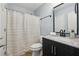 Bathroom featuring modern vanity, marble countertop, and a shower with grey and white shower curtain at 1069 Falling Water Se Dr, Smyrna, GA 30080