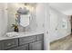 Modern bathroom with gray vanity, decorative mirror, and wood floors at 1069 Falling Water Se Dr, Smyrna, GA 30080