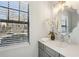 Bathroom vanity features a gray cabinet, white countertop, decorative mirror, and an elegant light fixture at 1069 Falling Water Se Dr, Smyrna, GA 30080