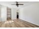 Bedroom features hard wood floors, ceiling fan, access to bathroom, and access to the stairs at 1069 Falling Water Se Dr, Smyrna, GA 30080