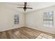 This bedroom features neutral walls, two windows, wood floors, and a ceiling fan at 1069 Falling Water Se Dr, Smyrna, GA 30080