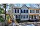 Charming two-story townhouse featuring light siding, dark shutters and inviting entryway with landscaped front yard at 1069 Falling Water Se Dr, Smyrna, GA 30080