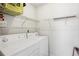 Laundry room with white appliances and wire shelving for convenient storage at 1069 Falling Water Se Dr, Smyrna, GA 30080