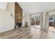 Living room showcasing a stone fireplace, wood mantle, and sliding glass doors to the deck at 1069 Falling Water Se Dr, Smyrna, GA 30080