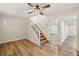 Spacious living room with a staircase and hardwood floors leading to an adjacent hallway at 1069 Falling Water Se Dr, Smyrna, GA 30080
