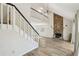 Spacious living room showcasing staircase, stone fireplace, and modern lighting fixture at 1069 Falling Water Se Dr, Smyrna, GA 30080