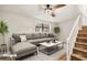 Staged living room with a large sectional sofa and view of the stairs at 1069 Falling Water Se Dr, Smyrna, GA 30080