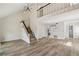 Living area featuring wood floors, modern lighting, and stairs to the second story at 1069 Falling Water Se Dr, Smyrna, GA 30080