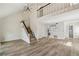 Spacious living room with hardwood floors, a chandelier, a staircase, and a view into the kitchen at 1069 Falling Water Se Dr, Smyrna, GA 30080