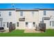 A view of the townhome's backyard including the fence, small patio and door to the home at 2502 Capella Sw Cir, Atlanta, GA 30331