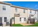 View of a backyard and exterior of three townhomes with fenced yard and patio space at 2502 Capella Sw Cir, Atlanta, GA 30331