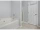 Clean bathroom with a soaking tub, separate shower, and tile floors at 2502 Capella Sw Cir, Atlanta, GA 30331