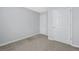 Neutral bedroom featuring soft carpet and two white doors, one likely a closet and the other an access way at 2502 Capella Sw Cir, Atlanta, GA 30331