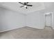 Large main bedroom features a tray ceiling, carpeted floors and a modern ceiling fan at 2502 Capella Sw Cir, Atlanta, GA 30331