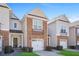 Inviting townhouse showcasing stone accents, neutral siding, and a convenient single-car garage for easy parking at 2502 Capella Sw Cir, Atlanta, GA 30331