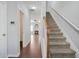 Bright hallway with hardwood floors, leading to a cozy living area featuring a fireplace, and a staircase at 2502 Capella Sw Cir, Atlanta, GA 30331