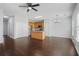 Spacious living room with a ceiling fan, wood floors, island kitchen, providing a seamless living experience at 2502 Capella Sw Cir, Atlanta, GA 30331