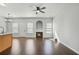 Bright living room featuring a cozy fireplace, ceiling fan, and natural light from the windows at 2502 Capella Sw Cir, Atlanta, GA 30331