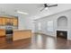 Open-concept living area with wood floors, a kitchen island, modern fireplace and ample natural light at 2502 Capella Sw Cir, Atlanta, GA 30331