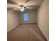 Carpeted bedroom with neutral walls, ceiling fan, and a window bringing in light at 322 Shawnee Trl, Dallas, GA 30157