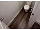 This powder room features wood-look flooring and modern fixtures at 322 Shawnee Trl, Dallas, GA 30157