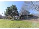 Secluded backyard with mature trees, bench, and a partial view of the home's back porch at 3440 Caleb Rd, Snellville, GA 30039